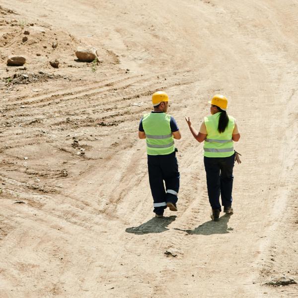  stock image personnel walking on dirt road