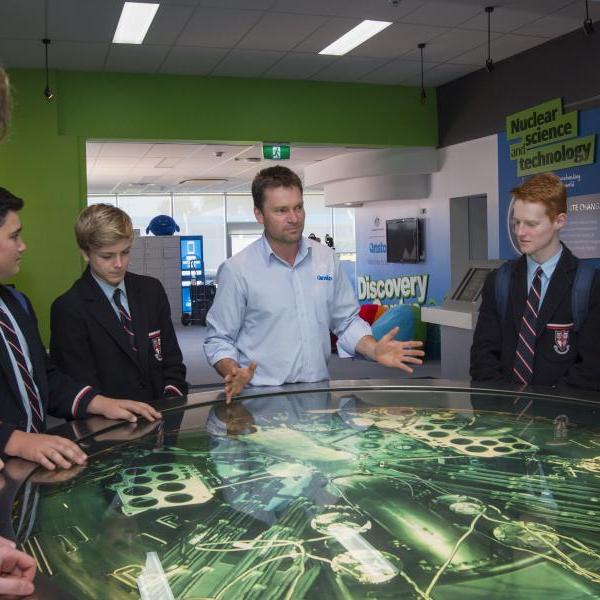 An image of tour guides showing students around ANSTO.