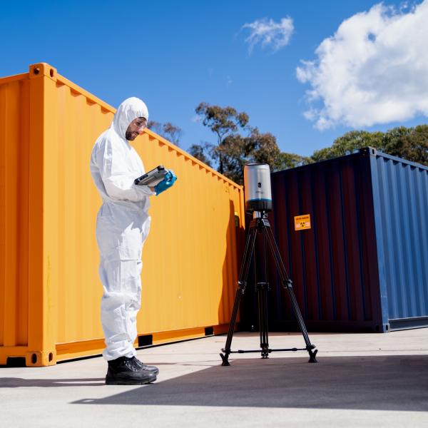 Operator using CORIS360 radiation detection product near shipping container