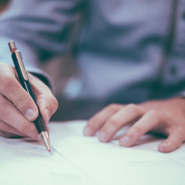 person writing on paper