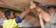 An image of archaeologists figuring out a rock's date