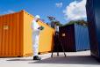 Operator using CORIS360 radiation detection product near shipping container