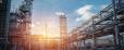 Pipeline and pipe rack of petroleum industrial plant with sunset sky