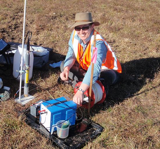 Dr Cath Hughes in the field sampling groundwater