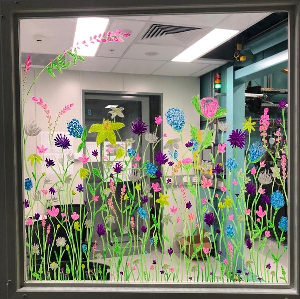 Flowers in bright colours have been drawn on the window looking into the MEX1 user cabin