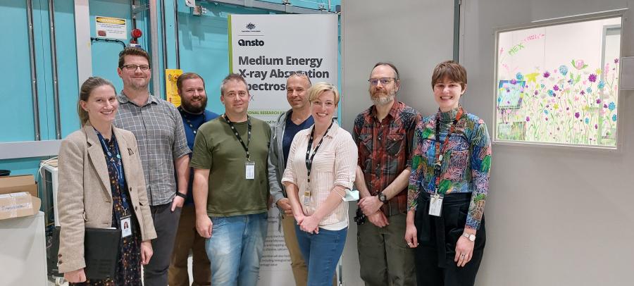 Group of scientists and engineers standing in front of the MEX1 user cabin