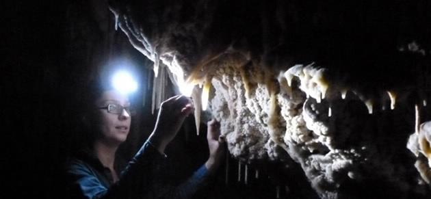 Monika Markowska studying cave formations.png