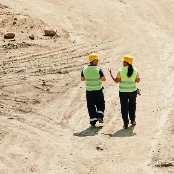 stock image personnel walking on dirt road