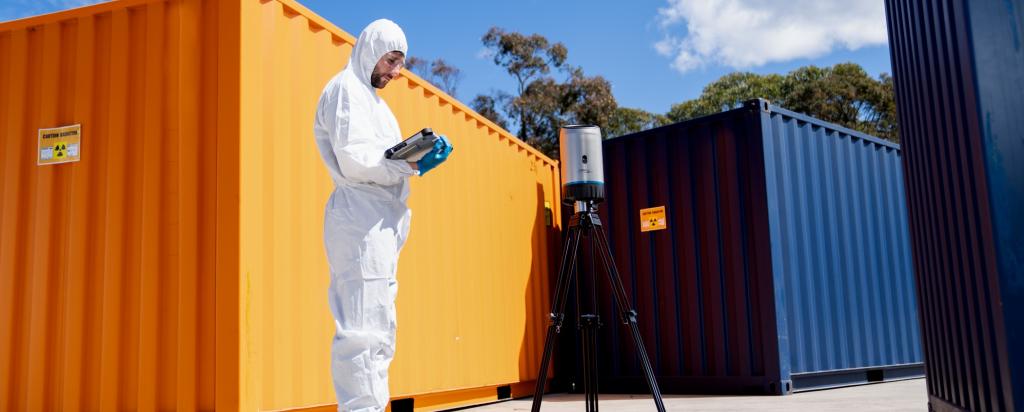 Operator using CORIS360 radiation detection product near shipping container